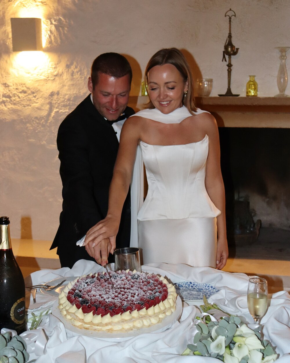 Newlyweds cutting the wedding cake together