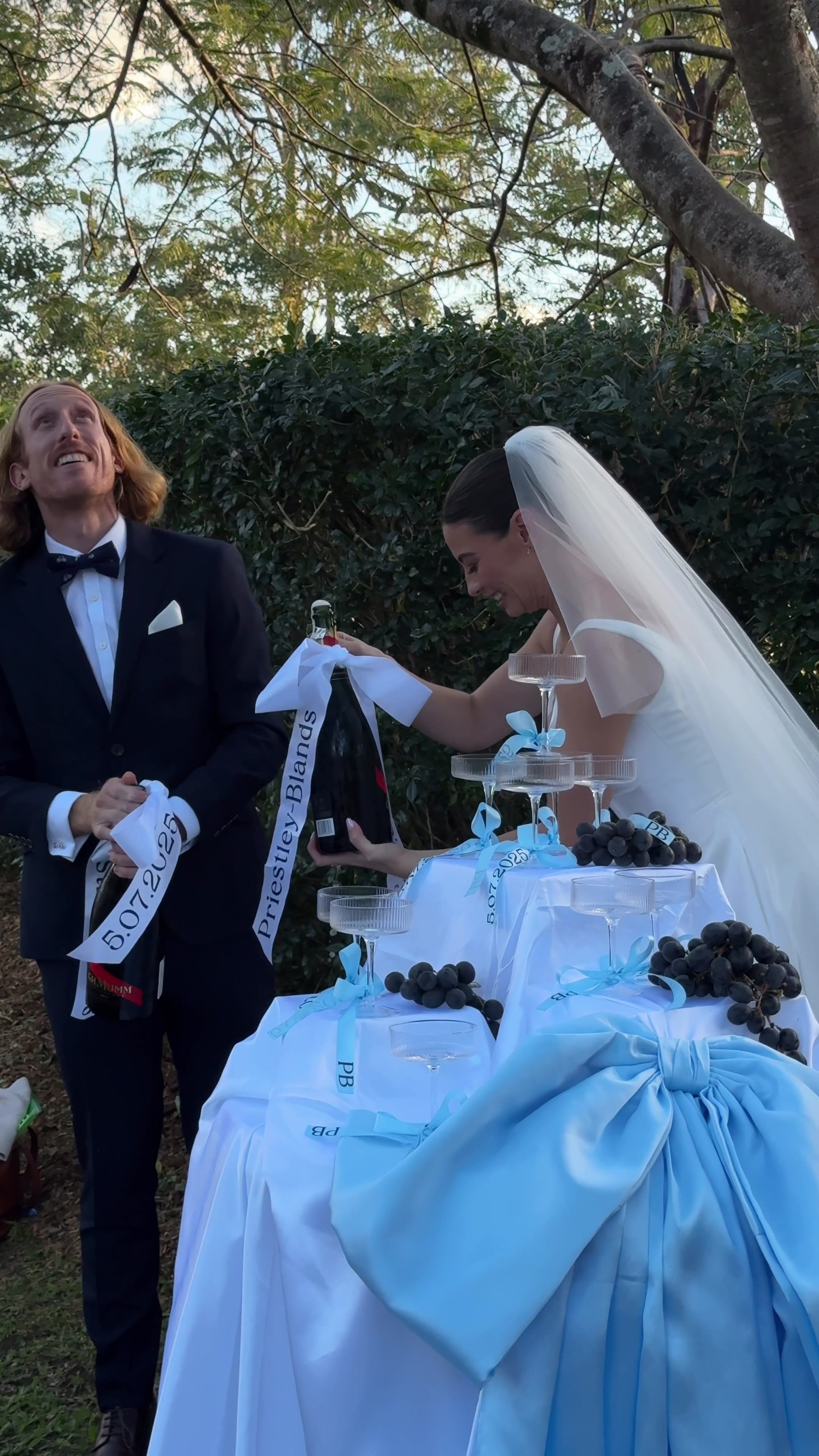 Bride and groom opening champagne at the reception
